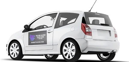 A white compact hatchback with a door magnet ad for a business called XJEMOTAGS.COM. The magnet features a purple butterfly logo and text that reads “YES WE CATER! Vehicle Magnets • Business Cards • Banners.”