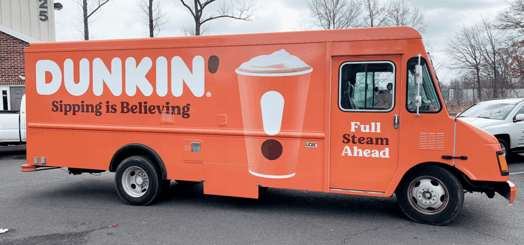 Dunkin’ Donuts fleet vehicle wrapped by Prime Graphics Lab, featuring vibrant orange branding graphics.